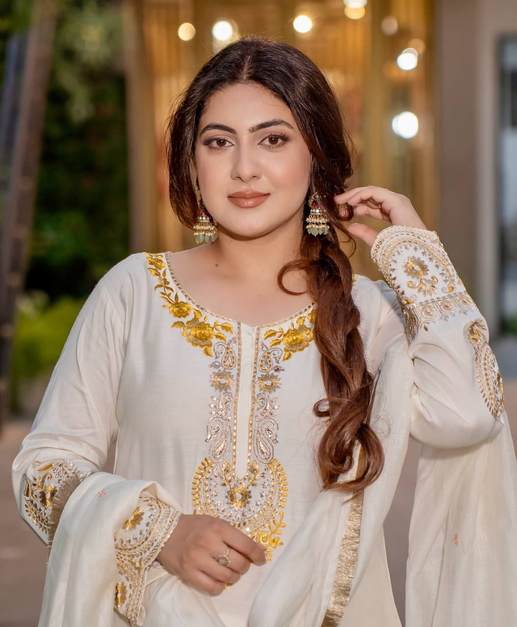 Radiant Heritage: Two Women Embodying Cultural Splendor in a Majestic Indian Courtyard