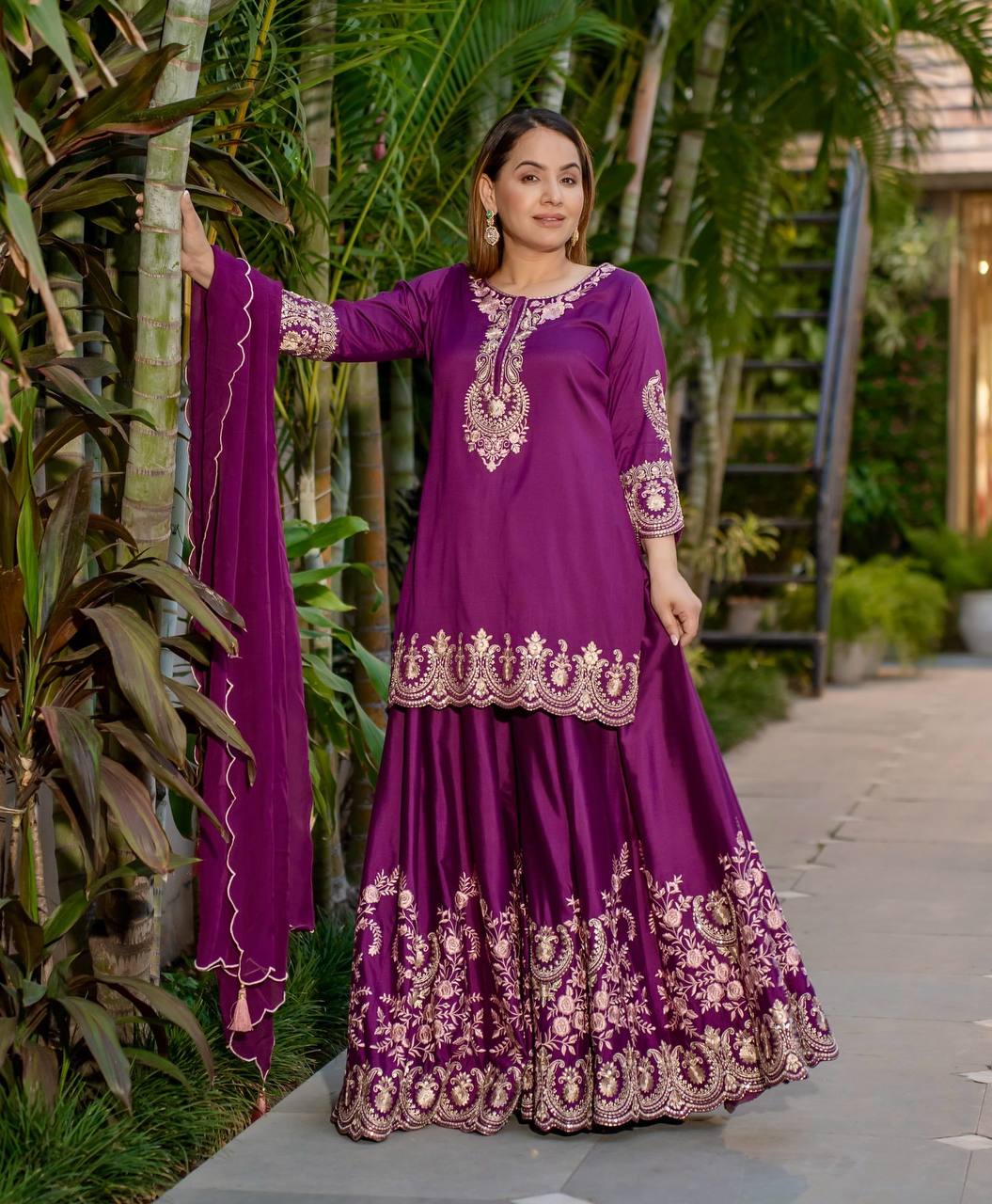 Radiant Heritage: Two Women Embodying Cultural Splendor in a Majestic Indian Courtyard