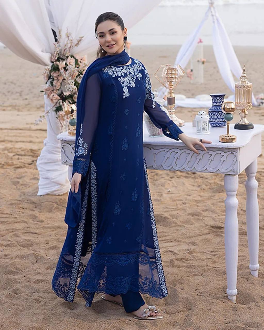 "Elegant Woman in Blue Embroidered Dress Amidst Natural Scenery"