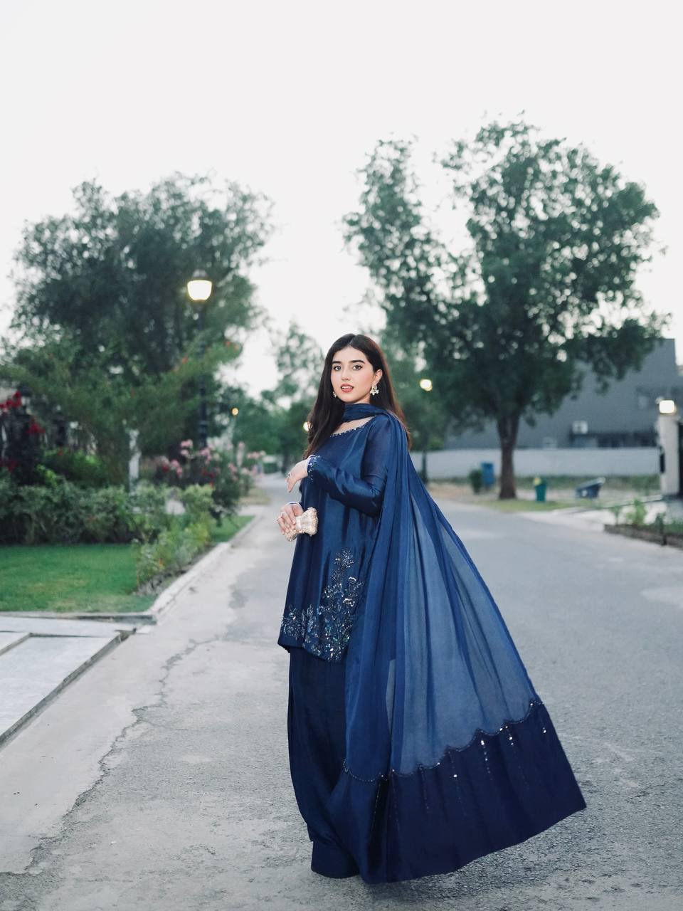 Elegant Harmony: The Blue Suited Muse Embracing Nature's Serenity in a Chic Urban Oasis
