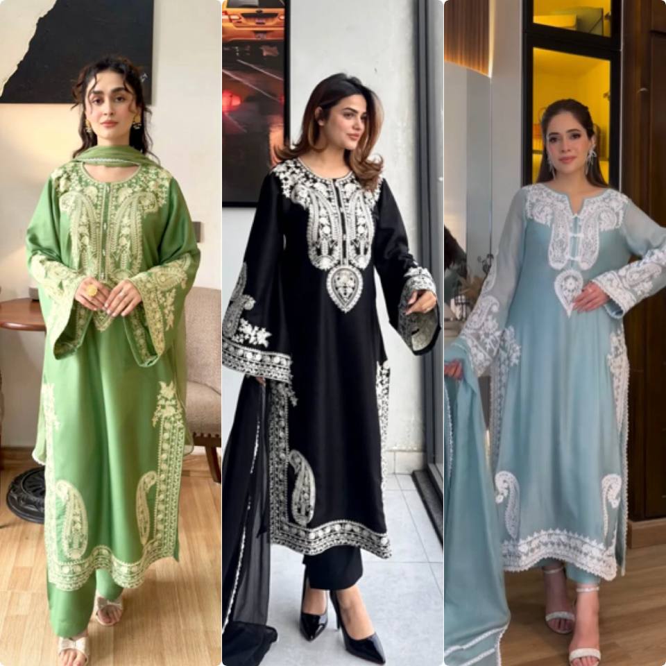 Three women wearing traditional outfits with intricate embroidery in different colors.